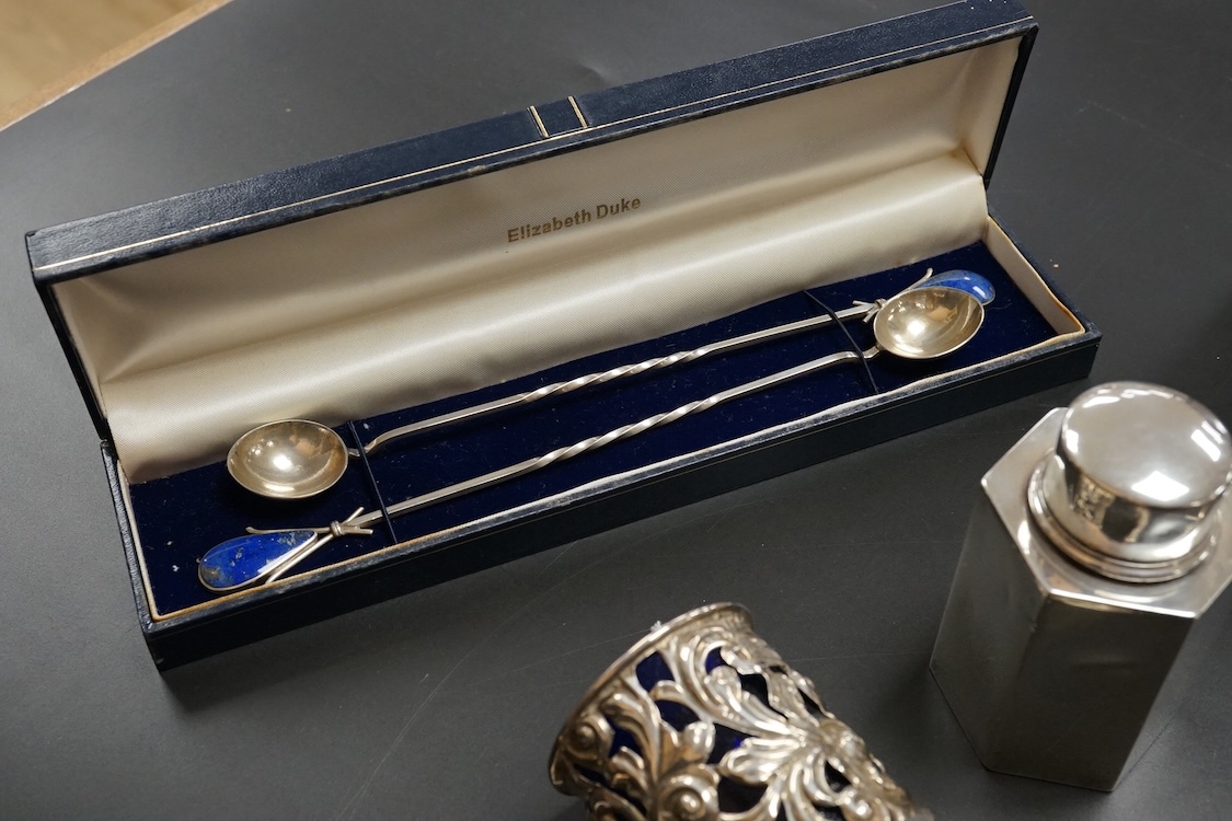 A small group of collectable silver including a pair of modern 925 and lapis lazuli set cocktail stirring spoons, an Edwardian small hexagonal tea caddy, a late Victorian pierced silver salt with blue glass liner and eig